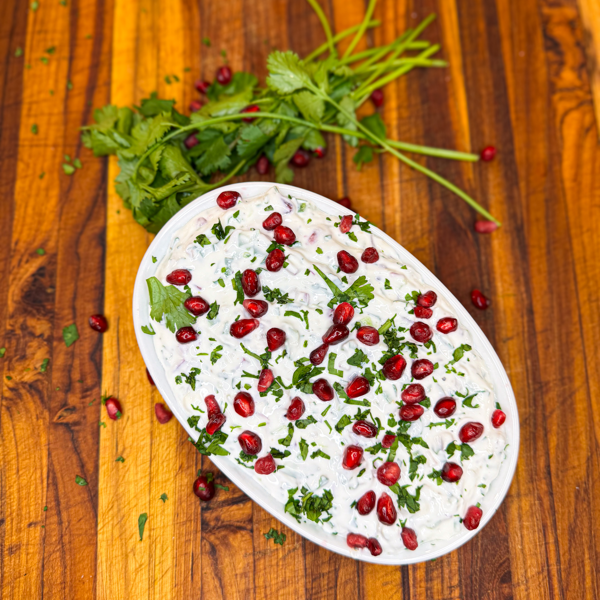 Festive holiday pomegranate and jalapeño dip. Made with greek yogurt, light cream cheese and topped with fresh cilantro this is a perfect healthy party dip!