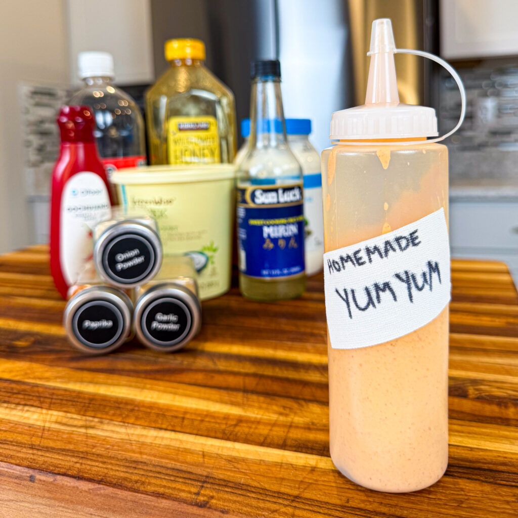 homemade low calorie bottled yum yum sauce with all ingredients blurred in background